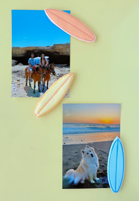 Beach-themed photos with people on horses and a dog with surfboard magnets on a light yellow background.